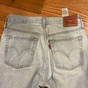 Levi 501 light wash jeans W27 L30. Straight leg, light distressing on thigh.